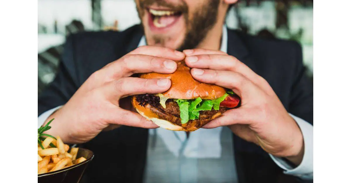 A guy eating a hamburger