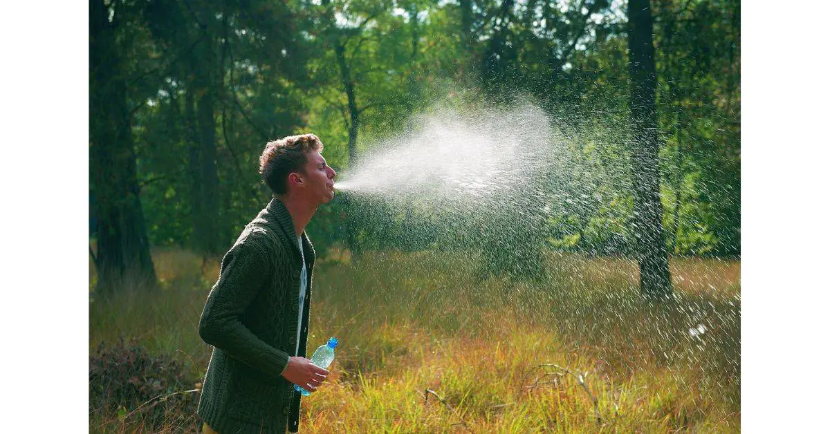 Man spitting water